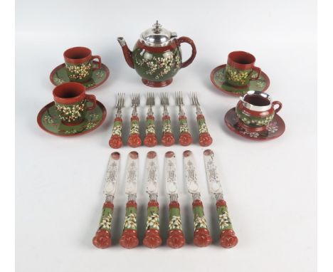 A Watcombe part tea service, with banded prunus blossom decoration, includes teapot, teapot stand, cream jug, three cups and 