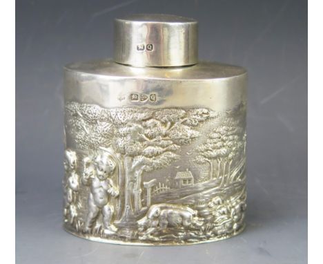 A Victorian silver tea caddy and lid, maker's mark worn, Chester, 1899, of oval outline with repousse decoration of putti in 
