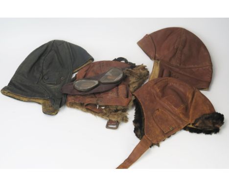 Two mid 1920's  brown leather brown leather flying helmets one with goggles and a German black leather flying helmet (pos. WW