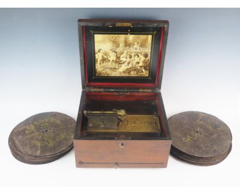 A late 19th century table top polyphon, contained in a mahogany case, with monochrome print to the lid interior, together wit