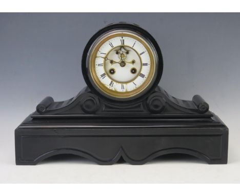 A late Victorian polished slate mantel clock, the drum-shaped case with 11cm Roman dial, the movement with in-sight escapemen