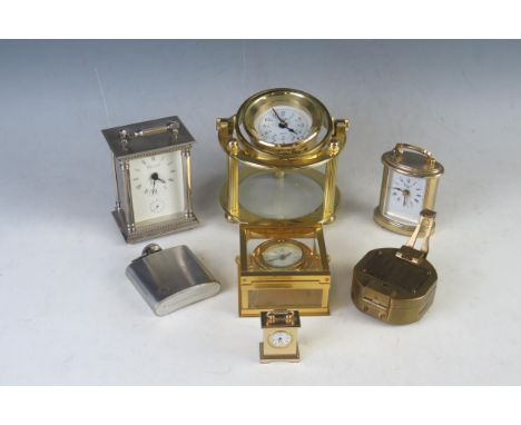 A lacquered brass and gimbal mounted quartz timepiece, with 6cm Arabic dial, raised on three pillars and circular base, 13.5c