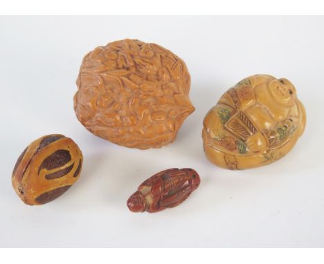 A Chinese carved walnut decorated with immortals, an ivorine netsuke and two other carved beans 