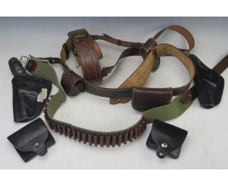 A reproduction stitched leather 'Sam Brown' bet, a canvas cartridge belt, a stitched leather gun belt with pouches, two Price