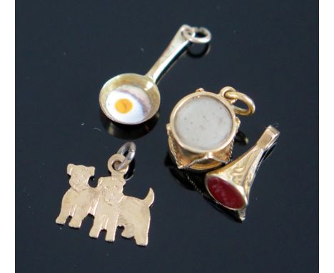 A Frying Pan with Enamel Egg Bracelet Charm (suspender stamped 9ct), Scottie dogs charm (stamped 9c), seal fob charm with car