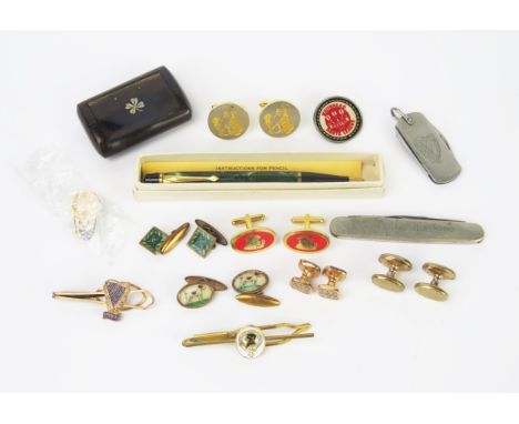 A collection of cuff links, 6 pairs, two tie clips, a Guinness penknife and pin, Whitbread Darts, another penknife and rosewo