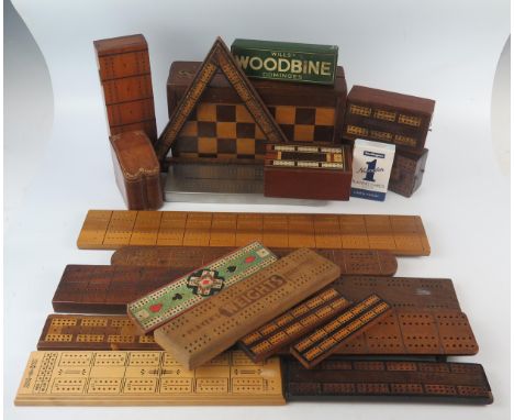 A collection of treen cribbage boards including a triangular cribbage board, folding chess/backgammon board, dominoes etc. 