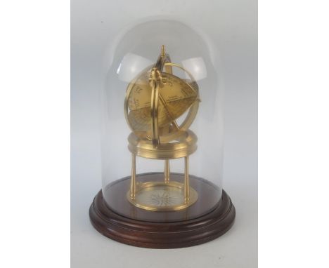 A 20th century lacquered brass astrolabe, with brass scales, raised on three columns on a circular base enclosing a compass, 