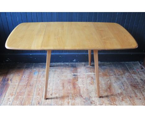 An Ercol dining table of rectangular outline with two drop leaves on square chamfered and tapering legs, 75 x 137cm extended.