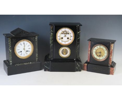 A late Victorian polished slate mantel clock, of rectangular outline, having a 10cm Roman dial, the circular movement with in