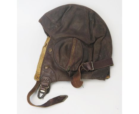 A WWII period RAF B-Type brown leather flying helmet, bears Air Ministry label 22c/65 size 7.1/8-7.3/8. 