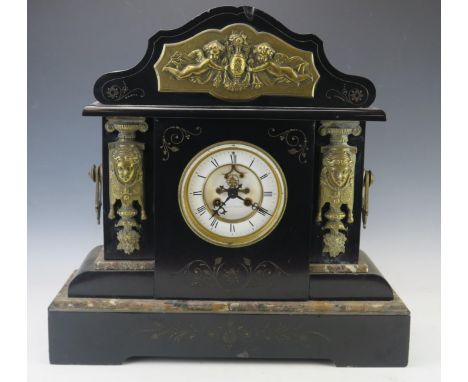 A large late Victorian polished slate mantel clock of arched outline, with applied gilt metal female mask and cherub decorati