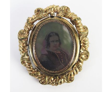 A Large Victorian Gilt Memorial Swivel Brooch decorated with a miniature portrait of a gentleman and photograph of a lady, 66