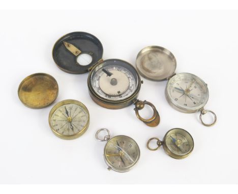 A brass cased military style compass and four others 