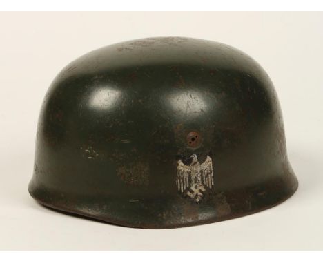 A SECOND WORLD WAR NAZI 'ARMY' PARA HELMET, painted in green, parts possibly replaced.