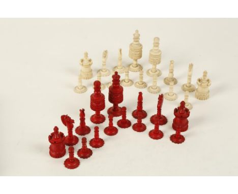 A 19TH CENTURY CARVED AND TURNED BONE CHESS SET with white and stained red chessmen