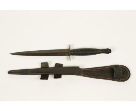 A POST SECOND WORLD WAR COMMANDO KNIFE with an alloy grip, William Rodgers, Sheffield, England, with a leather scabbard