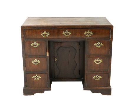 {} A George III Mahogany Kneehole Desk, 3rd quarter 18th century, the moulded top above a pine-lined drawer with three furthe