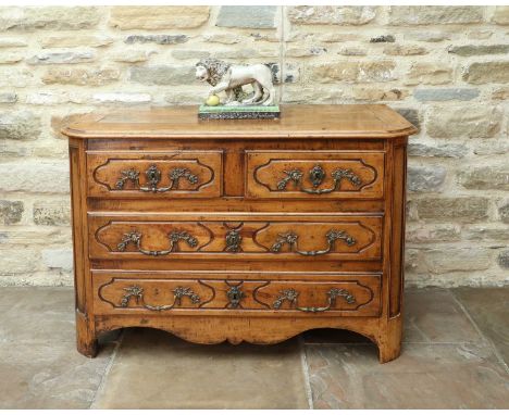 An 18th Century French Walnut Commode, the top of three-plank construction with cleated ends above two short and two long dra