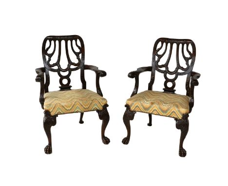 A Pair of Victorian Carved Mahogany Chippendale-Style Carver Chairs, late 19th century, recovered in close-nailed geometric f