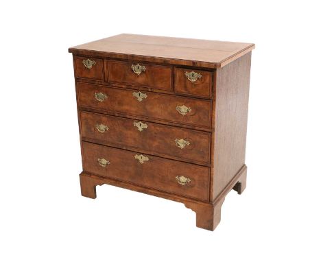 A George II Figured Walnut, Boxwood, Ebony-Strung and Oak-Sided Straight Front Chest of Drawers, the quarter-veneered top wit