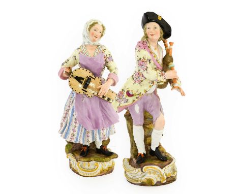 A Pair of Meissen Porcelain Figures of Rustic Musicians, late 19th century, each standing, she playing a hurdy-gurdy, he the 