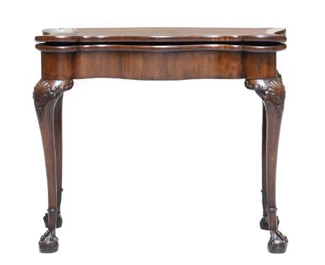 A George II Walnut Foldover Card Table, mid 18th century, of serpentine-shape form, the hinged leaf enclosing a velvet interi