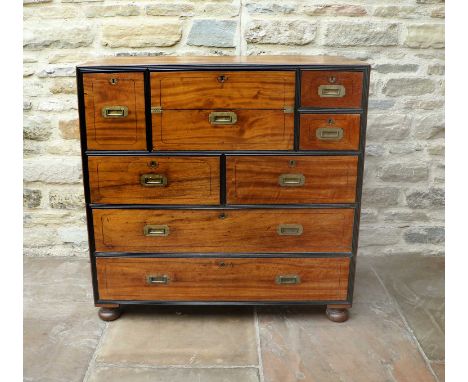 A Mid 19th Century Anglo-Chinese Camphorwood and Ebonised Secretaire Campaign Chest, in two sections, the central drawer with