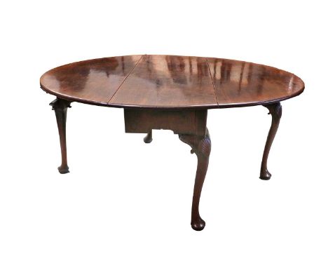 A George III Mahogany Six-Seater Gateleg Dining Table, circa 1770, with two dropleaves to form an oval, on shell-carved cabri