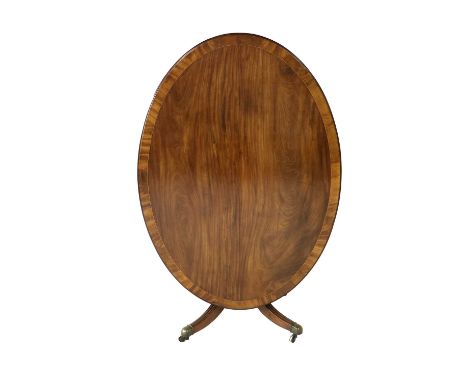 A George III Mahogany, Crossbanded, Boxwood and Ebony-Strung Oval Dining Table, late 18th century, the flip top pivoting on a