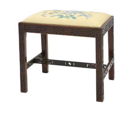 ^ A George III Chippendale-Style Blind-Fret-Carved Dressing Stool, 19th century, the later yellow and blue floral drop-in sea