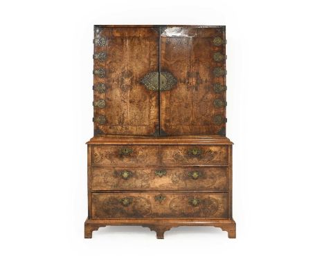 A George II Figured, Featherbanded and Brass Mounted Walnut Cabinet on Chest, second quarter 18th century, the quarter-veneer