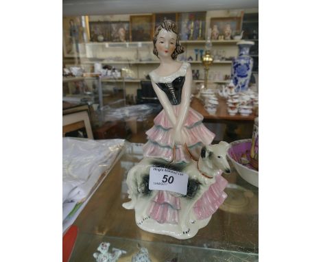 A Goebel Art Deco figurine depicting a lady beside a dog.   CONDITION REPORT:  22cm high