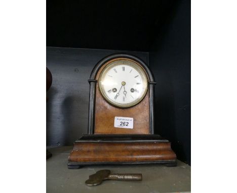 A Victorian ebonised and burr walnut mantel clock.