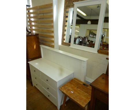 A modern white finished three piece bedroom suite, comprising chest of six drawers, king size bedstead, wall mirror.