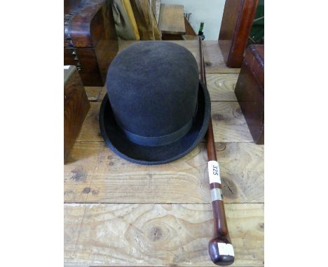 A good quality swagger stick with white metal ferrule together with a vintage bowler hat 