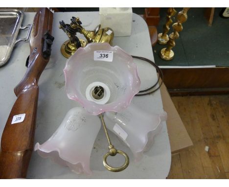 An early 20th Century brass rise and fall light having three frosted glass shades 