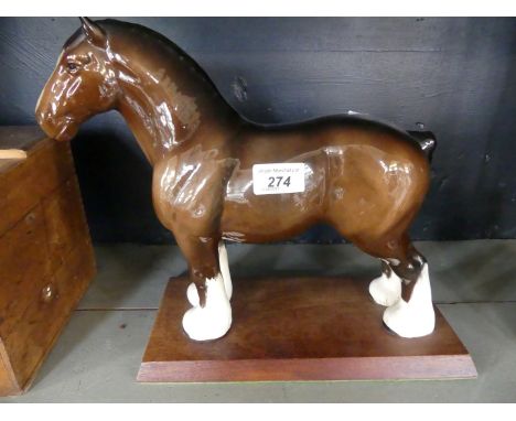 A large Beswick model of a Shire Horse on a wooden plinth base, height 28cm