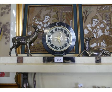 An Art Deco marble and slate mantel clock, the circular face flanked by bronzed spelter stag and doe 