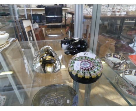 A vintage Perthshire glass paperweight together with a Caithness paperweight and a glass model of a seated cat 