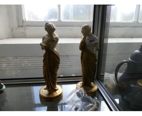 A pair of Royal Worcester figurines each depicting semi-nude shy ladies with gilt dresses and highlights, each with puce fact