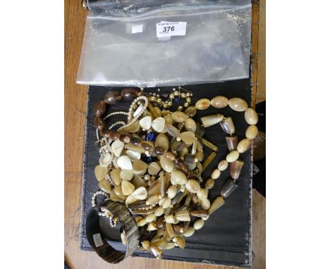 A quantity of beads to include; a string of horn beads, a horn bangle and immitation pearls (Qty) 