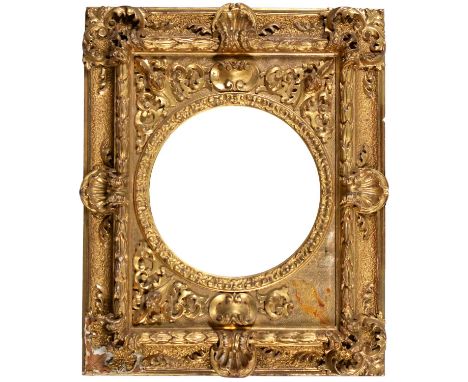 A giltwood and composition picture frame, c1870, with high relief applied masks and Venus shells, sight 29cm diam, 64 x 52cm 