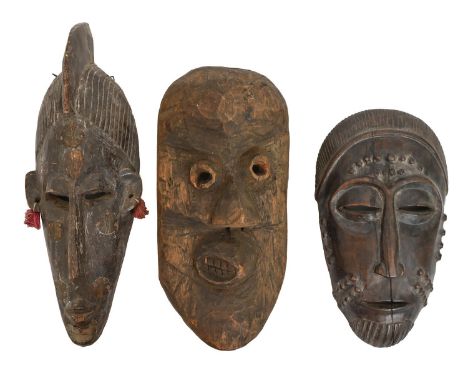 Tribal art. West Africa - a carved wood bambara marka face mask, 39cm and a baule portrait mask, 31cm and another, possibly D