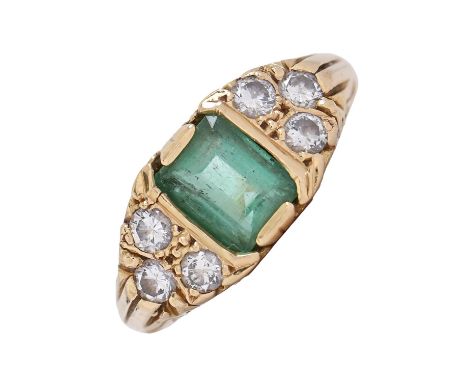 An emerald and diamond ring, the step cut emerald approximately 5 x 7mm, between triple diamond shoulders, in 18ct gold, Birm