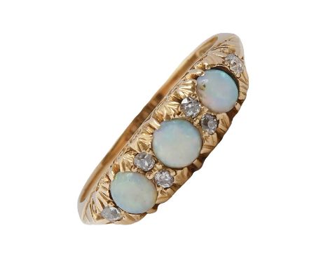 An opal and diamond ring, early 20th c, in gold marked 18c, 3.4g, size M  Opals scratched from wear; all stones present