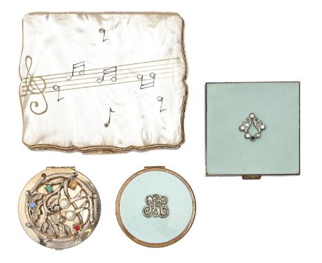 A Stratton gold plated and mother of pearl musical compact, c1960, 80mm l, two other, smaller compacts and a faux gem set gol