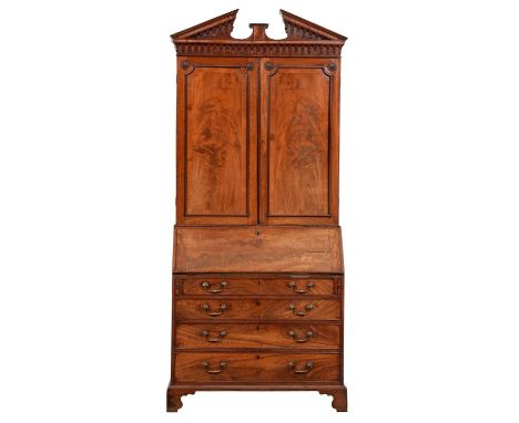 A George III mahogany bureau bookcase, with open triangular pediment and pear drop frieze, fitted with adjustable shelves and