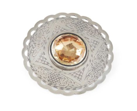 A VICTORIAN GEM-SET PLAID BROOCH  UNMARKED  of circular outline with a pierced scallop border, collet set with a yellow foil 
