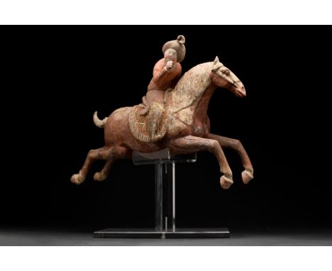 Ca. 618-906 AD A very attractive and dynamic figure of terracotta Chinese Polo Rider. The lady is depicted on a galloping hor